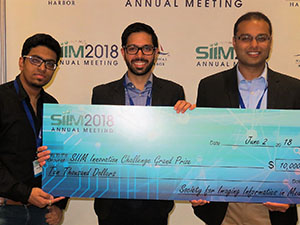 Akshay Goel, MD; Soumya Ghosh receiving their check for SIIM18