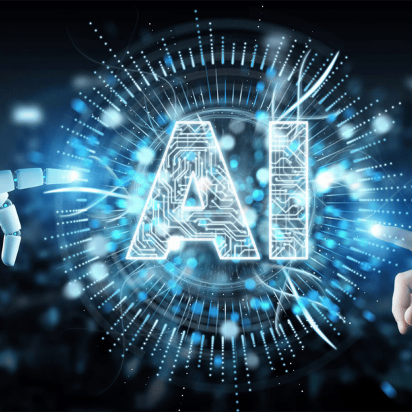 A robotic hand and a human hand touching the letters AI, made of circuits