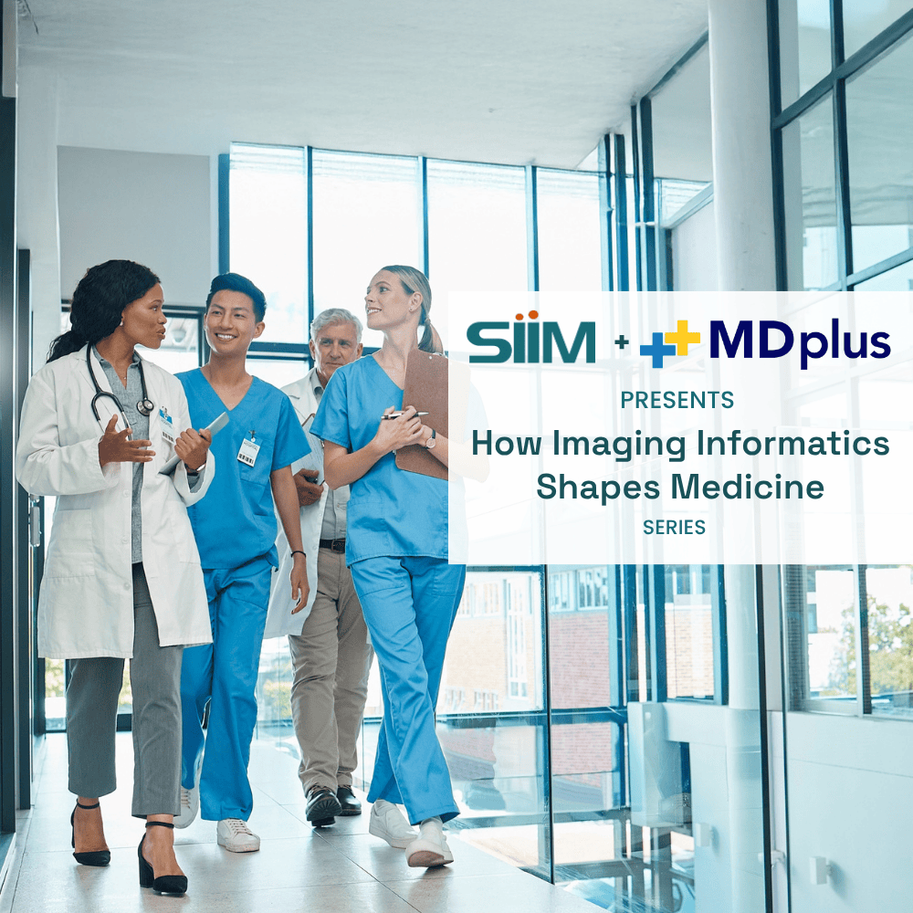 Medical professionals discussing imaging informatics in a hospital corridor.