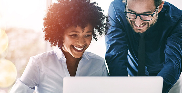 two people looking at a computer